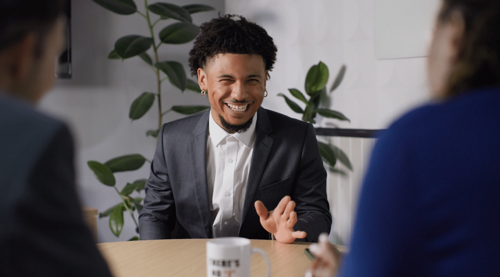 Over the shoulder shot of man at desk laughing