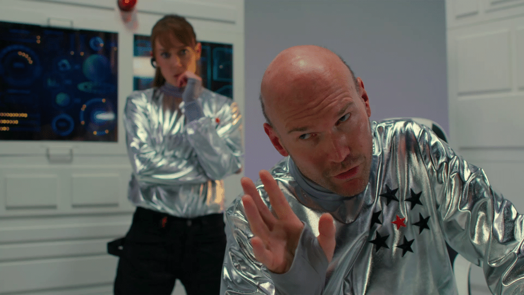 A man and a woman dressed like Star Trek characters talking in a space ship.