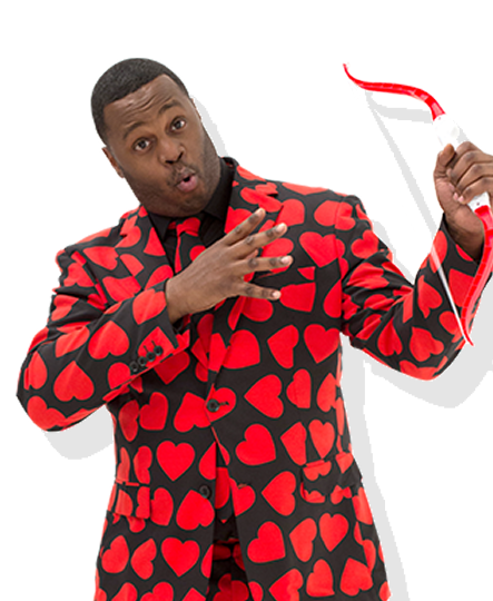 Javone Prince dressed in a heart print suit with a bow and arrow like Cupid.